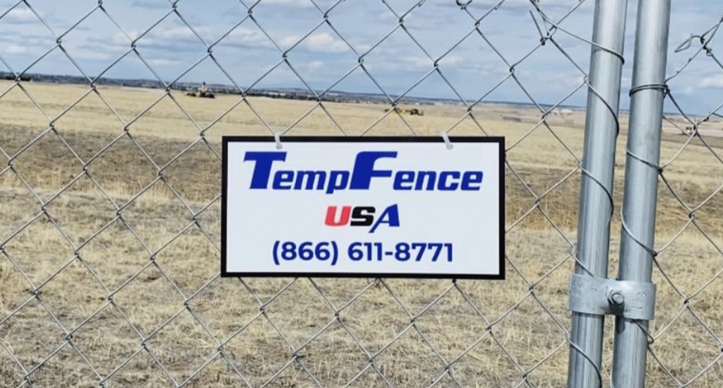 Temp Fence USA plastic sign on chain link fence